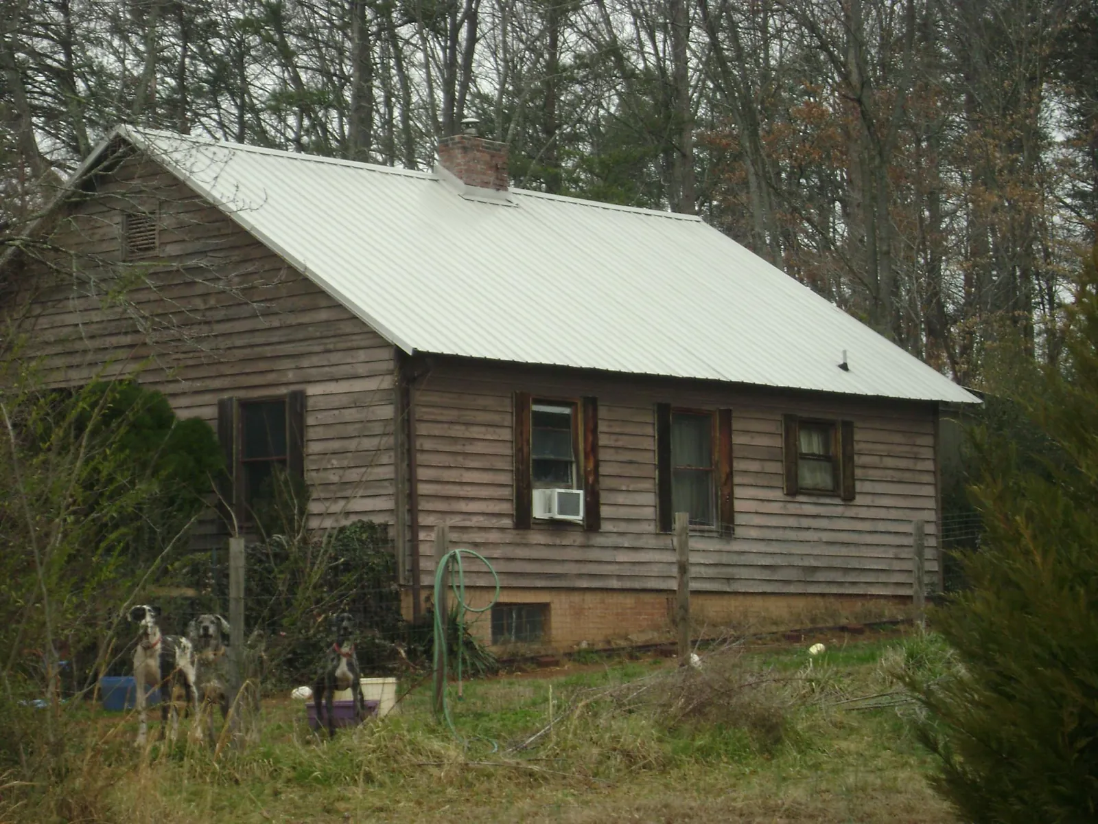 White metal roof on an old wood sided farmhouse, from a Metal Roof Installation job in Galeton